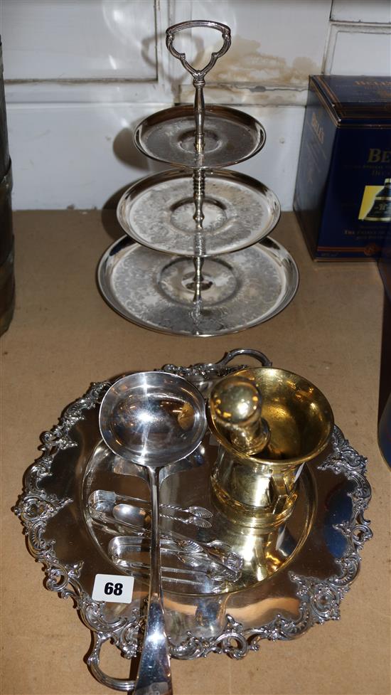 Plated cake stand, plated cooler sand, pair of silver sugar tongs, plated ladle and spoon and a brass pestle